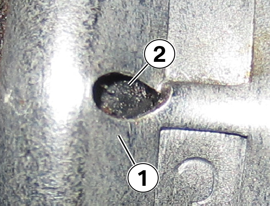 Close-up picture of the ferrule (1) and the ferrule inspection hole (2)